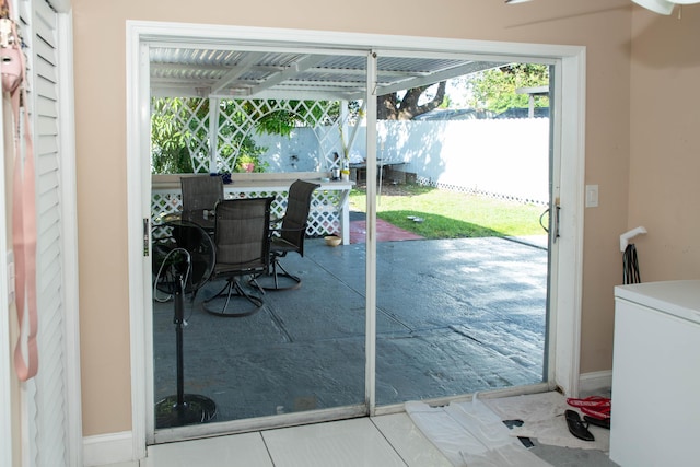 doorway to outside with tile patterned flooring