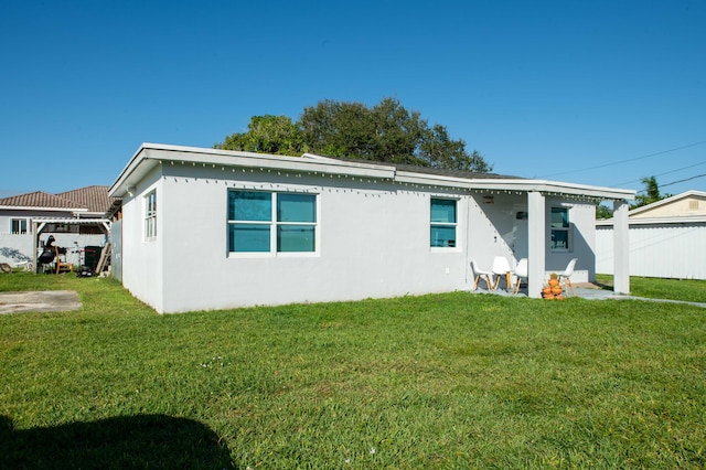 back of house featuring a yard