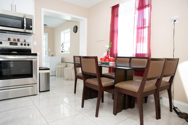 dining space featuring light tile patterned floors