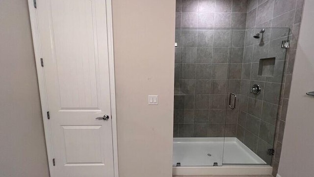 bathroom with a shower with door