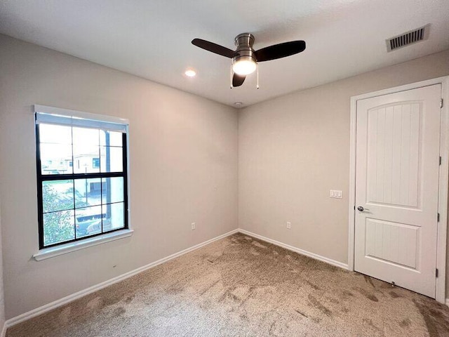 carpeted empty room with ceiling fan