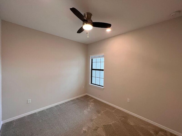 empty room featuring carpet flooring and ceiling fan