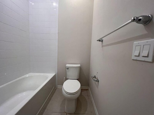 bathroom with shower / washtub combination, tile patterned flooring, and toilet