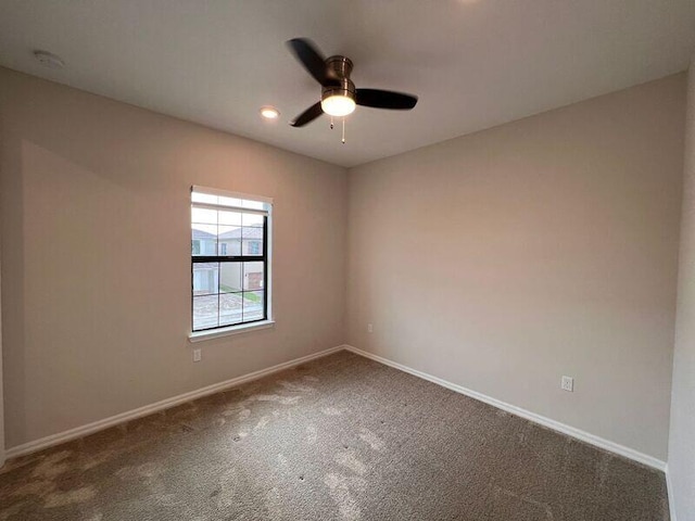 unfurnished room with carpet and ceiling fan