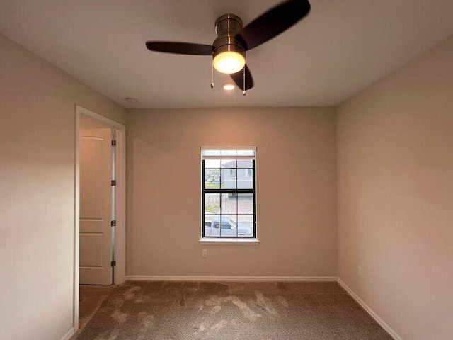 spare room with carpet and ceiling fan