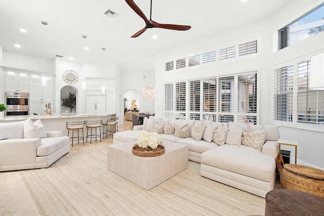 tiled living room with ceiling fan