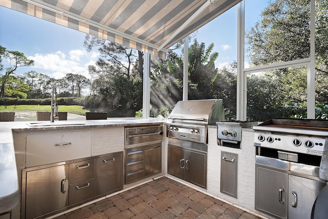 view of patio with area for grilling, a grill, and sink