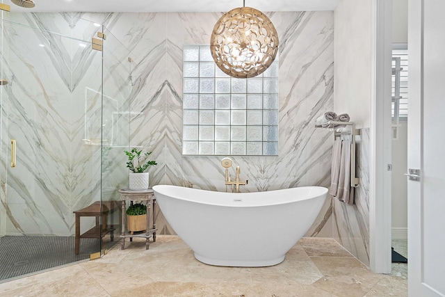 bathroom featuring a healthy amount of sunlight and separate shower and tub