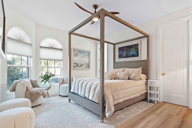 bedroom with light hardwood / wood-style flooring and ceiling fan