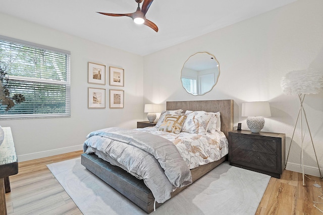 bedroom with ceiling fan and light wood-type flooring