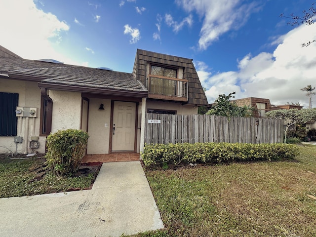 view of exterior entry with a yard