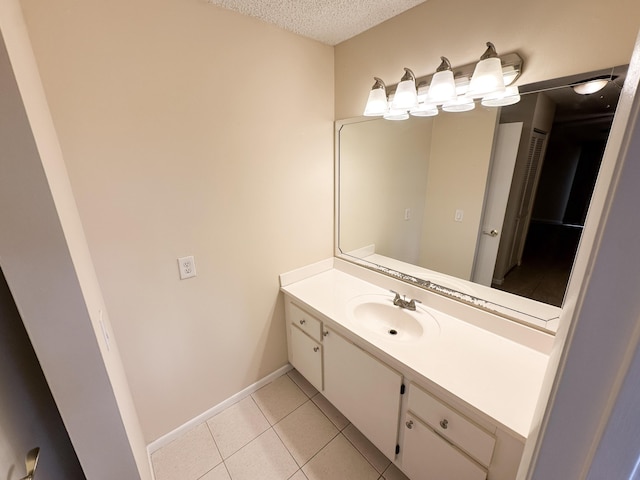 bathroom featuring tile patterned flooring, vanity, and a textured ceiling