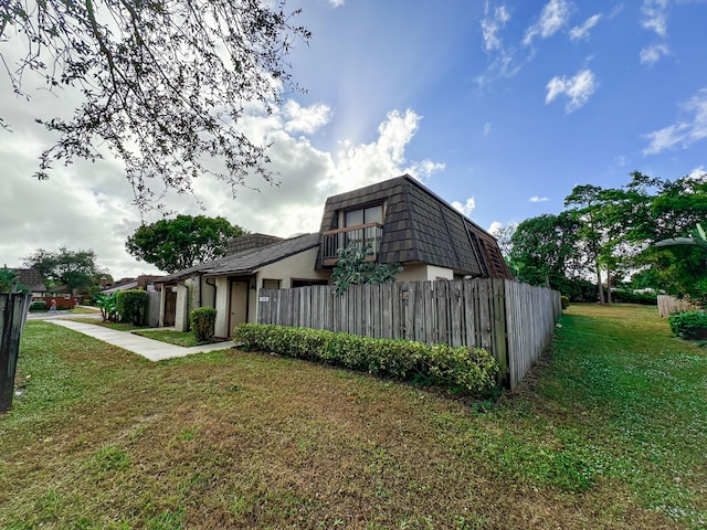 view of side of home with a lawn