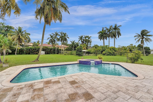 view of pool featuring an in ground hot tub, a yard, and a patio area