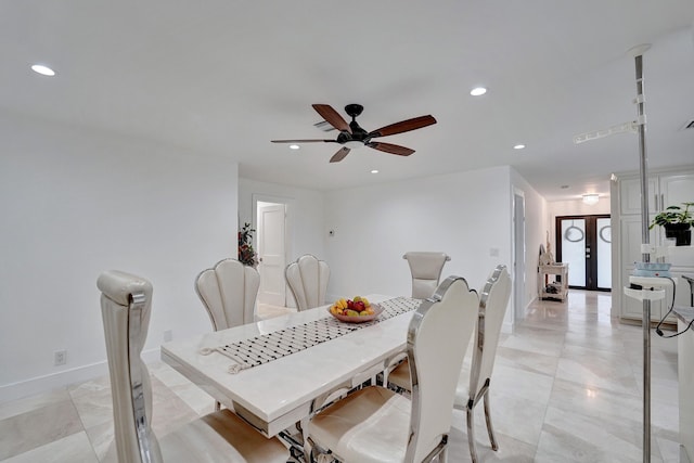 dining room featuring ceiling fan and french doors