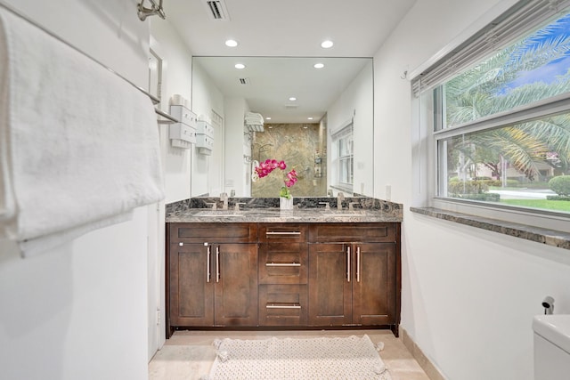 bathroom with vanity, toilet, and walk in shower