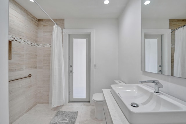 bathroom featuring tile patterned flooring, toilet, sink, and a shower with shower curtain