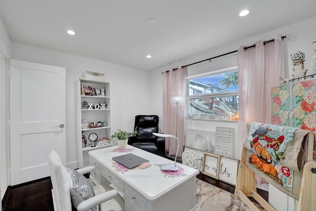 home office with light hardwood / wood-style flooring