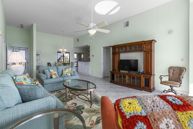 living room featuring vaulted ceiling, ceiling fan, and light tile patterned flooring