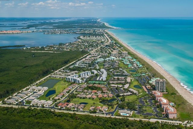 drone / aerial view featuring a beach view and a water view