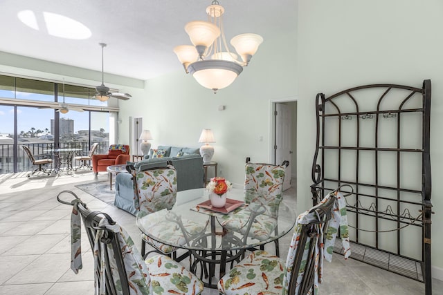 dining area with ceiling fan with notable chandelier and light tile patterned floors