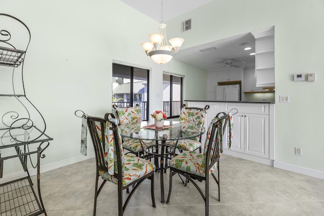 tiled dining area with ceiling fan with notable chandelier