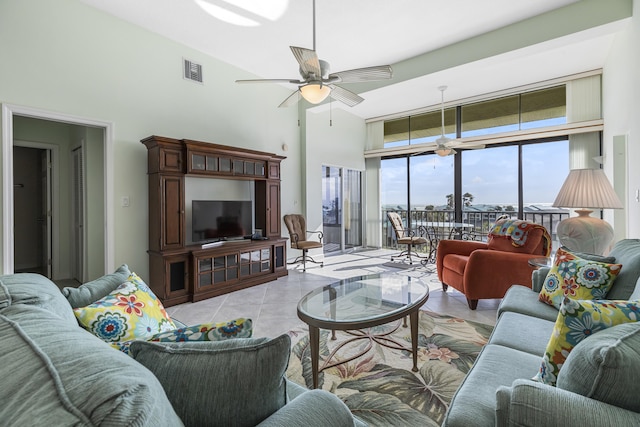 living room with light tile patterned flooring, expansive windows, and ceiling fan