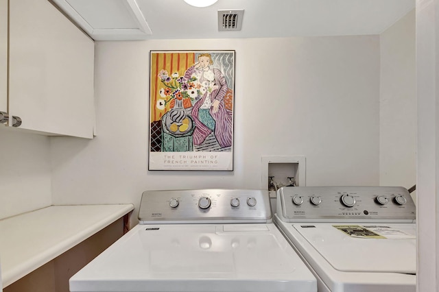 washroom with cabinets and independent washer and dryer