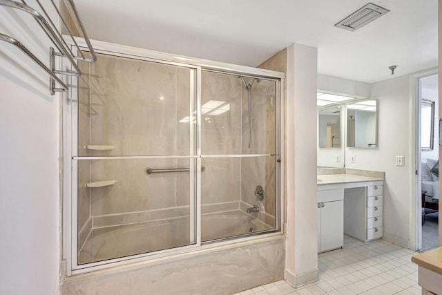 bathroom featuring shower / bath combination with glass door, tile patterned flooring, and vanity