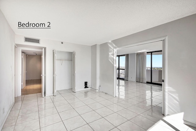 spare room featuring a textured ceiling