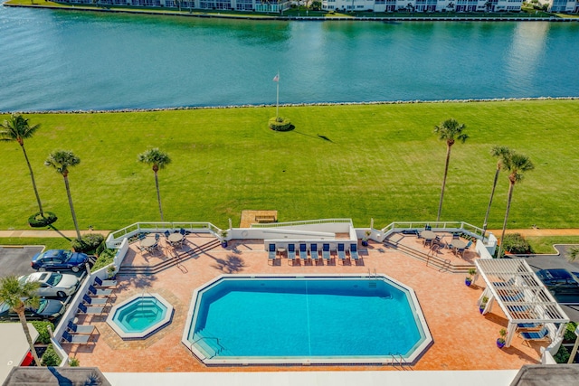 view of swimming pool featuring a water view