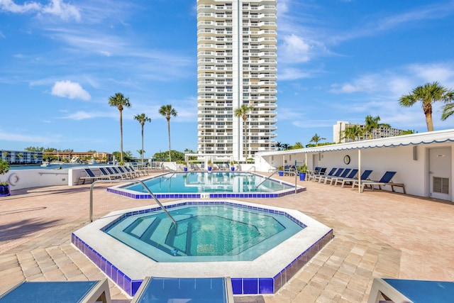 view of pool with a community hot tub and a patio