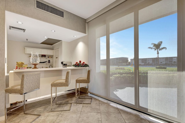 kitchen with white cabinetry and light tile patterned floors