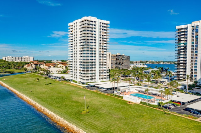 birds eye view of property with a water view and a beach view