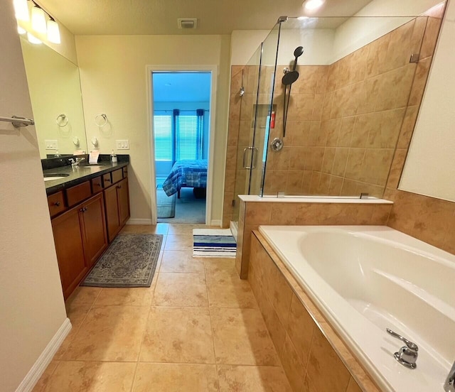 bathroom featuring tile patterned floors, plus walk in shower, and vanity