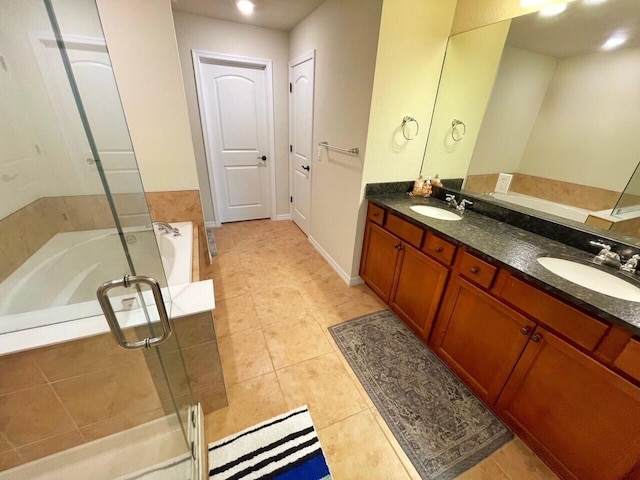 bathroom featuring tile patterned flooring, vanity, and shower with separate bathtub