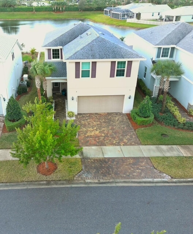 view of front of property featuring a water view and a garage