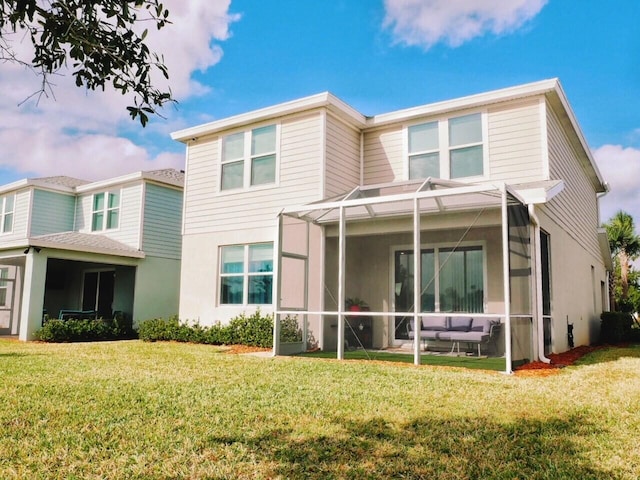 back of property with glass enclosure and a lawn