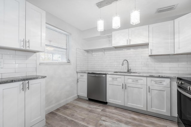 kitchen with white cabinetry, sink, appliances with stainless steel finishes, and light hardwood / wood-style flooring