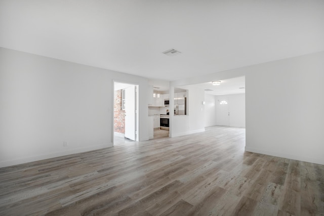 unfurnished living room with wood-type flooring