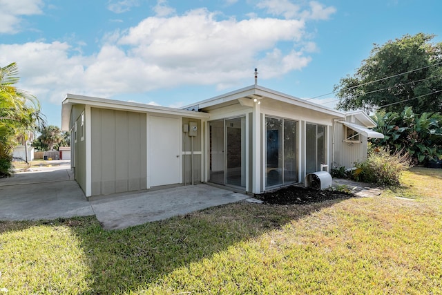 rear view of house with a yard and a patio area