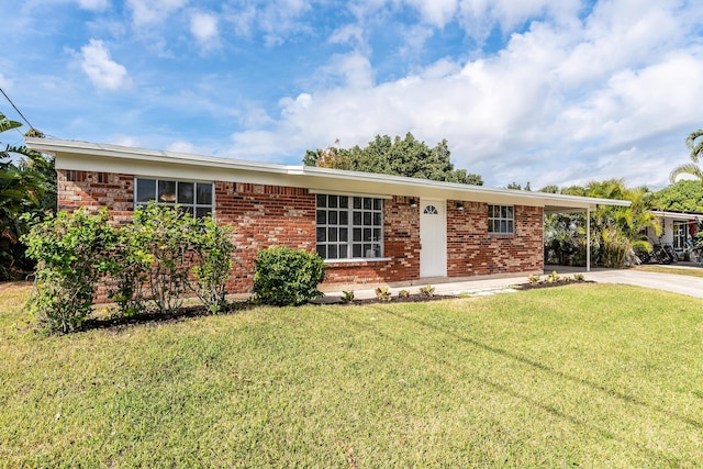 ranch-style house with a front yard and a carport