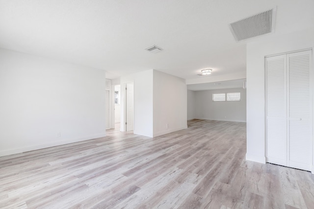 unfurnished room with light wood-type flooring