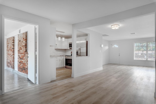 unfurnished living room featuring light hardwood / wood-style flooring