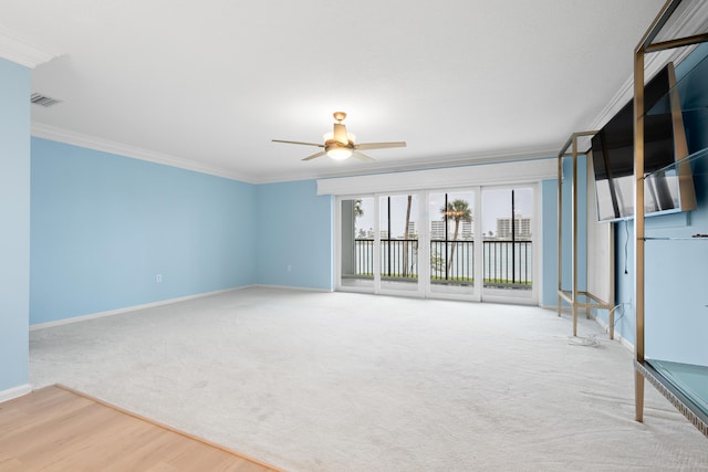 empty room featuring hardwood / wood-style floors, ceiling fan, and crown molding