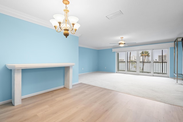 unfurnished room with crown molding, ceiling fan with notable chandelier, and light wood-type flooring