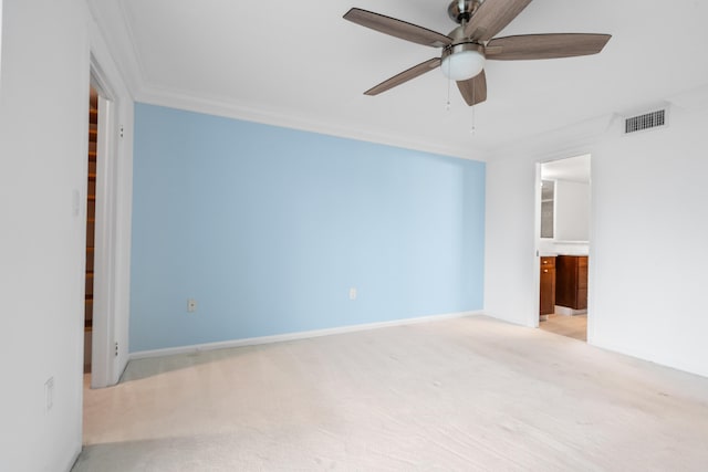 carpeted empty room featuring ceiling fan and crown molding