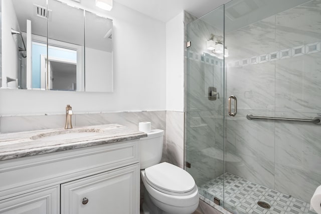 bathroom with vanity, an enclosed shower, and toilet