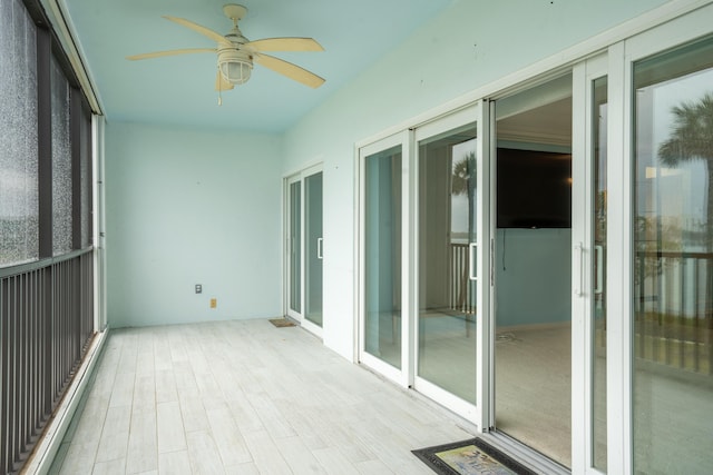 unfurnished sunroom with ceiling fan