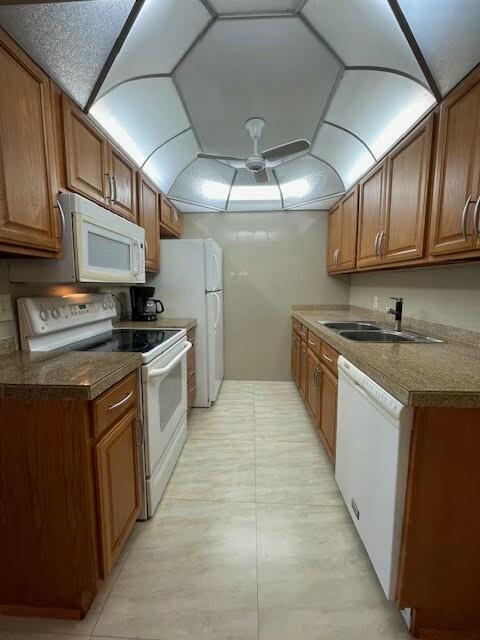 kitchen with ceiling fan, white appliances, and sink